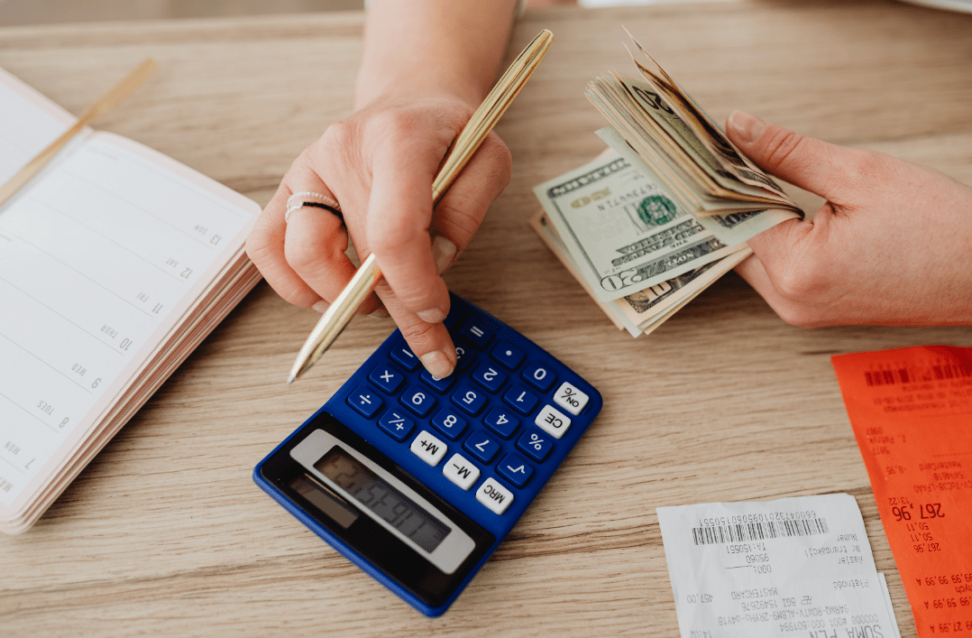 Woman calculating bills on a calculator