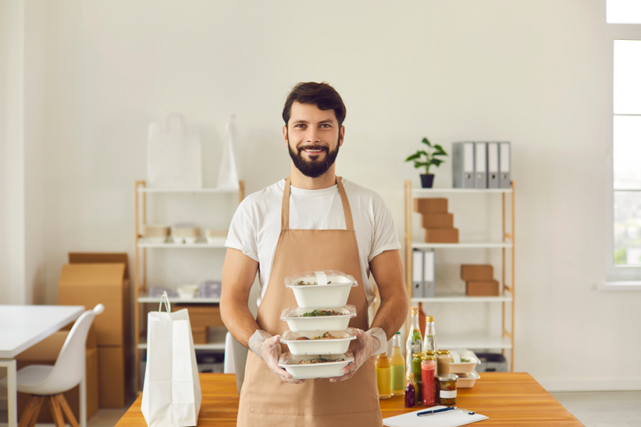 A person holding a stack of bowls